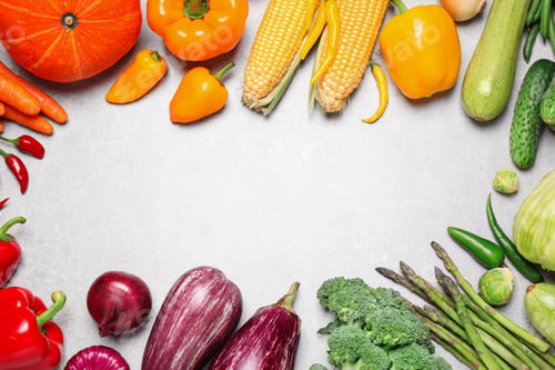 Preview: Frame of different fresh vegetables on grey table, flat lay. Space for text