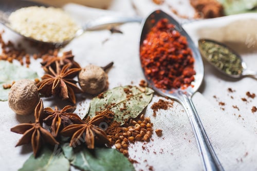 Preview: mix of different spices and herbs on a table with decor