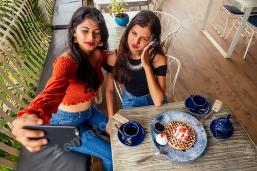 Preview: fashionable indian friends couple of two woman making selfie mobile phone