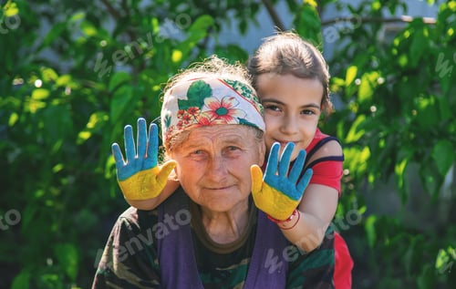Preview: Child and grandmother hand drawn flag of Ukraine. Selective focus.