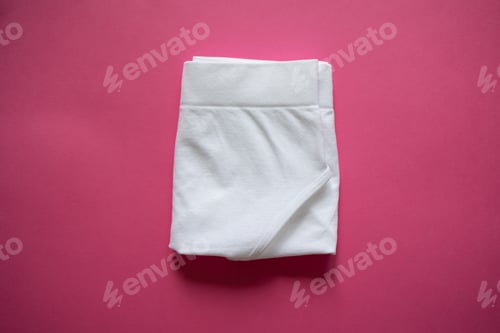 Preview: Tall women's white briefs folded on a pink background