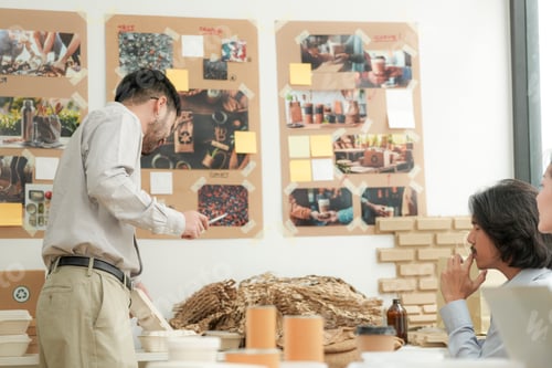 Preview: Young man presenting biodegradable utensils during an eco friendly product