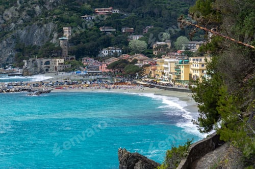 Preview: Scenic view of Monterosso al Mare beach with vibrant blue water and historic buildings in Italy