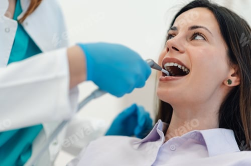 Preview: Dentist performing dental check up on smiling patient