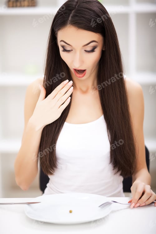 Preview: Eating disorder. Girl is holding a plate and trying to put a pea on the fork