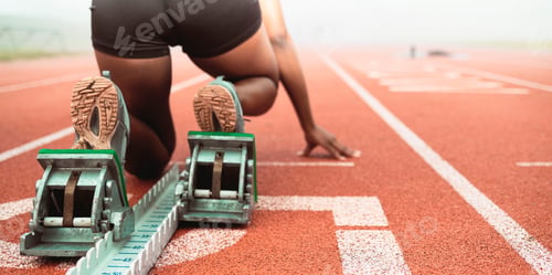 Preview: Get set. Rearview shot of an unrecognizable young sportswoman taking her mark on starting blocks.