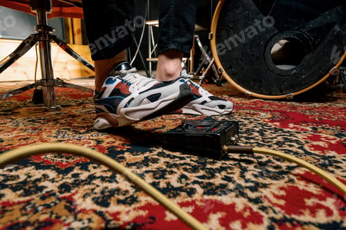 Preview: man's foot pressing bass drum pedal in recording studio drummer drumming indoors closeup