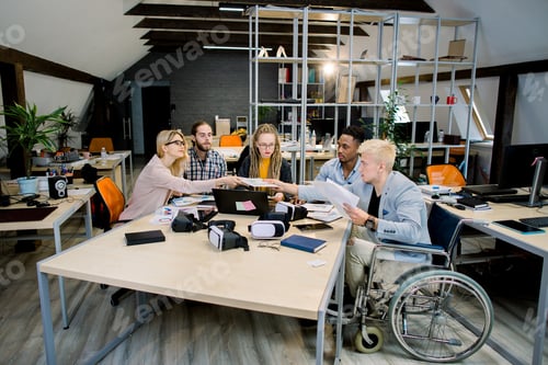 Preview: Office life, business meeting. Multicultural group of creative young coworkers discussing business