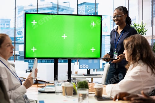 Preview: Diverse work team discusses corporate strategies with a big green screen