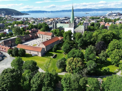 Preview: Drone view of the Nidaros Cathedral surrounded by greenery in Trondheim, Norway
