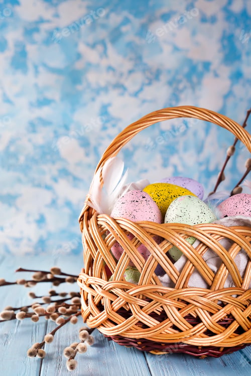 Preview: Easter basket filled with colorful eggs on a blue background