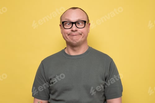 Preview: Crazy looking man in glasses making funny faces squinting eyes