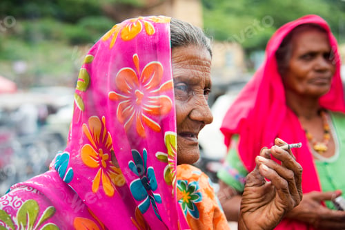Preview: Old age woman smoking Indian handmade cigarette.