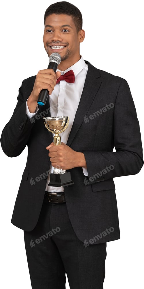 Preview: a man in a suit and bow tie holding a microphone