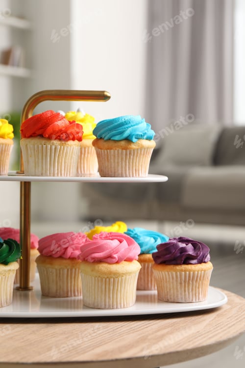 Preview: Delicious cupcakes with bright cream on wooden table indoors