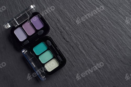 Preview: Set of two eye shadow palettes on dark slate background