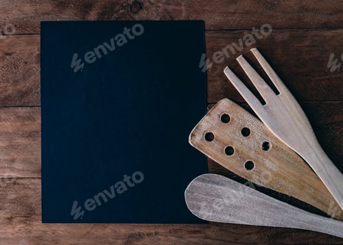 Preview: An invitation to cook created with wooden food utensils.