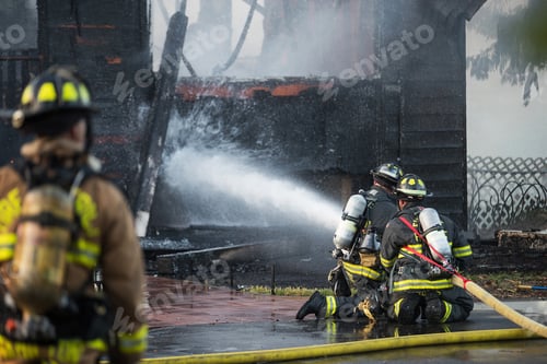 Preview: Firefighter sprays water on burning house fire