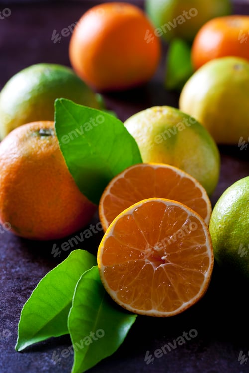 Preview: Organic tangerines and lemons on dark background