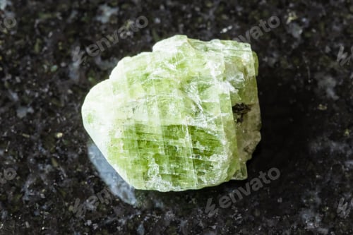Preview: sample of raw diopside crystal on black granite