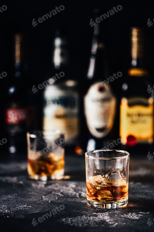 Preview: Whiskey with ice on a dark table