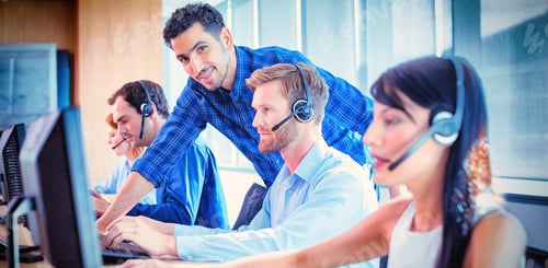 Preview: Male supervisor assisting telemarketer at call center