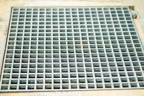 Preview: Closeup drain sump and grating on the floor outdoor.