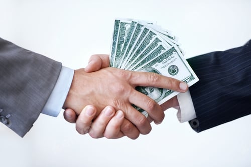 Preview: If you do this for me...Studio shot of two men shaking hands after making a monetary deal.