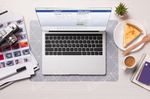Preview: office desk with laptop with facebook website on screen, flat lay