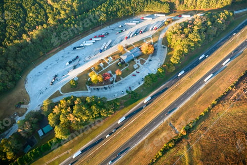 Preview: Aerial view of big rest area near busy american freeway with fast moving cars