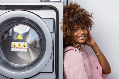 Preview: Smiling Woman Leans Against a Silver Washing Machine