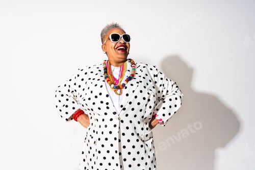 Preview: Funny senior black woman wearing stylish clothing isolated in studio