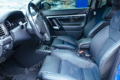 Preview: the interior of the vehicle with the front door open , the steering wheel seat