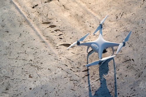 Preview: Drone with camera close up on the grey background. Preparation quadrocopter to start flying.