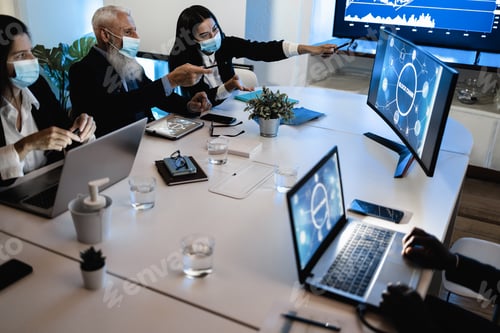 Preview: Business teamwork doing meeting inside fintech company office wearing safety mask