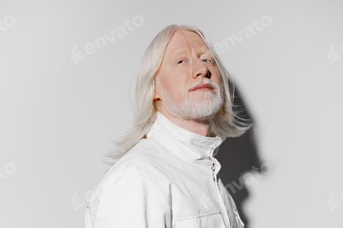 Preview: Man with Long White Hair Poses in Studio