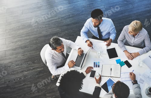 Preview: Delegating tasks around the table. Shot of a group of businesspeople having a meeting in an office.