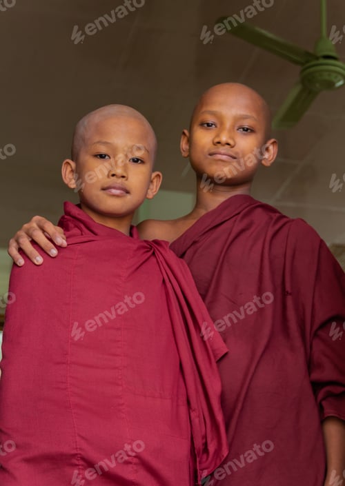 Preview: Mandalay, Myanmar - June, 25 2012: Monk boys standing in queue for food
