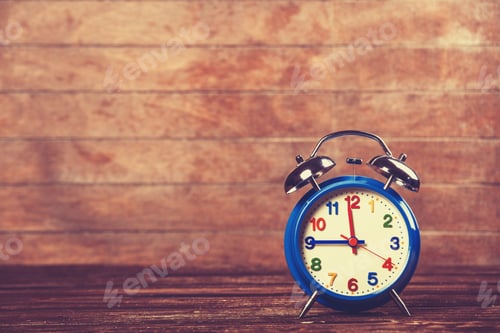 Preview: Retro alarm clock on a table. Photo in retro color image style