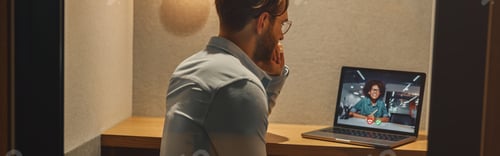Preview: Male freelancer have a videoconference with colleague while sitting in cozy coworking