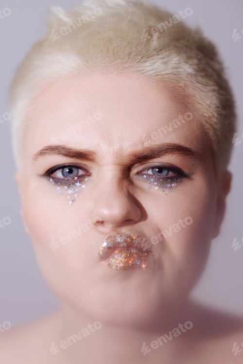 Preview: Portrait of a beautiful woman with short hair with glitter on her lips