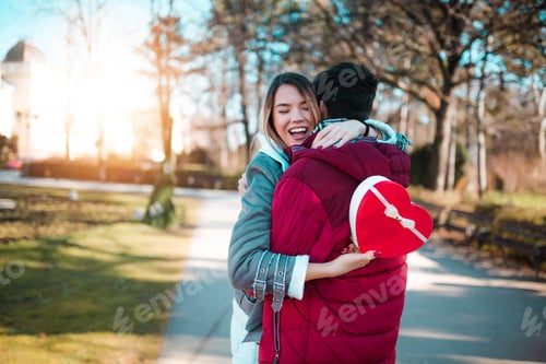 Preview: Young couple with present in the park