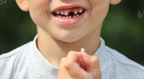 Preview: The child lost a tooth. Selective focus.Concept baby tooth