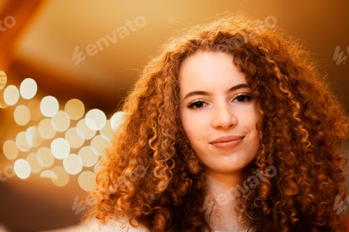 Preview: Beauty model woman with beautiful make up and curly hair style over holiday lights background