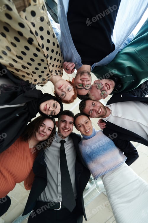 Preview: A diverse group of business professionals standing together in a powerful, united pose, captured