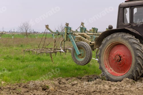 Preview: Tractor cultivates and milling soil on field. Farm work.