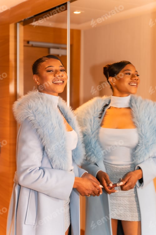 Preview: Rich black ethnic woman in hotel room, luxury concept, standing by the mirror
