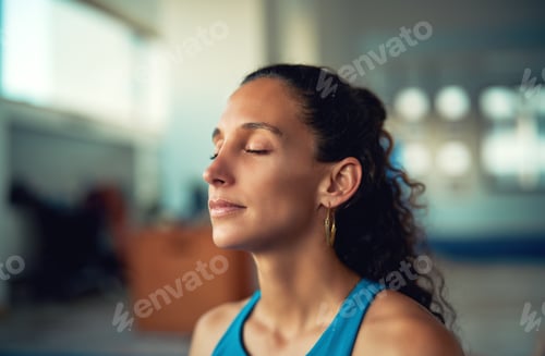 Preview: head portrait mid adult latina woman with eyes closed meditating indoors