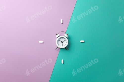 Preview: Pills, tablets and white alarm clock on colorful background. Medical and health concept
