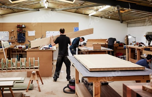 Preview: Two men working with wood in a furniture workshop.